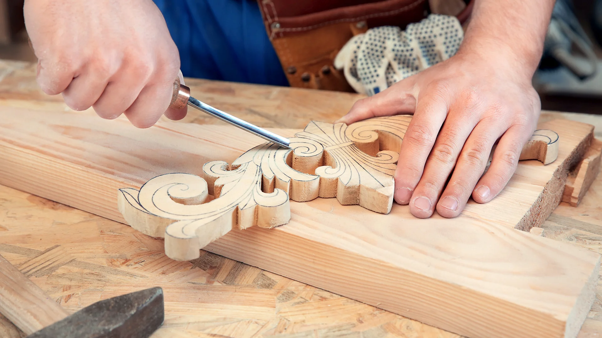 Carpenter with chisel in workshop