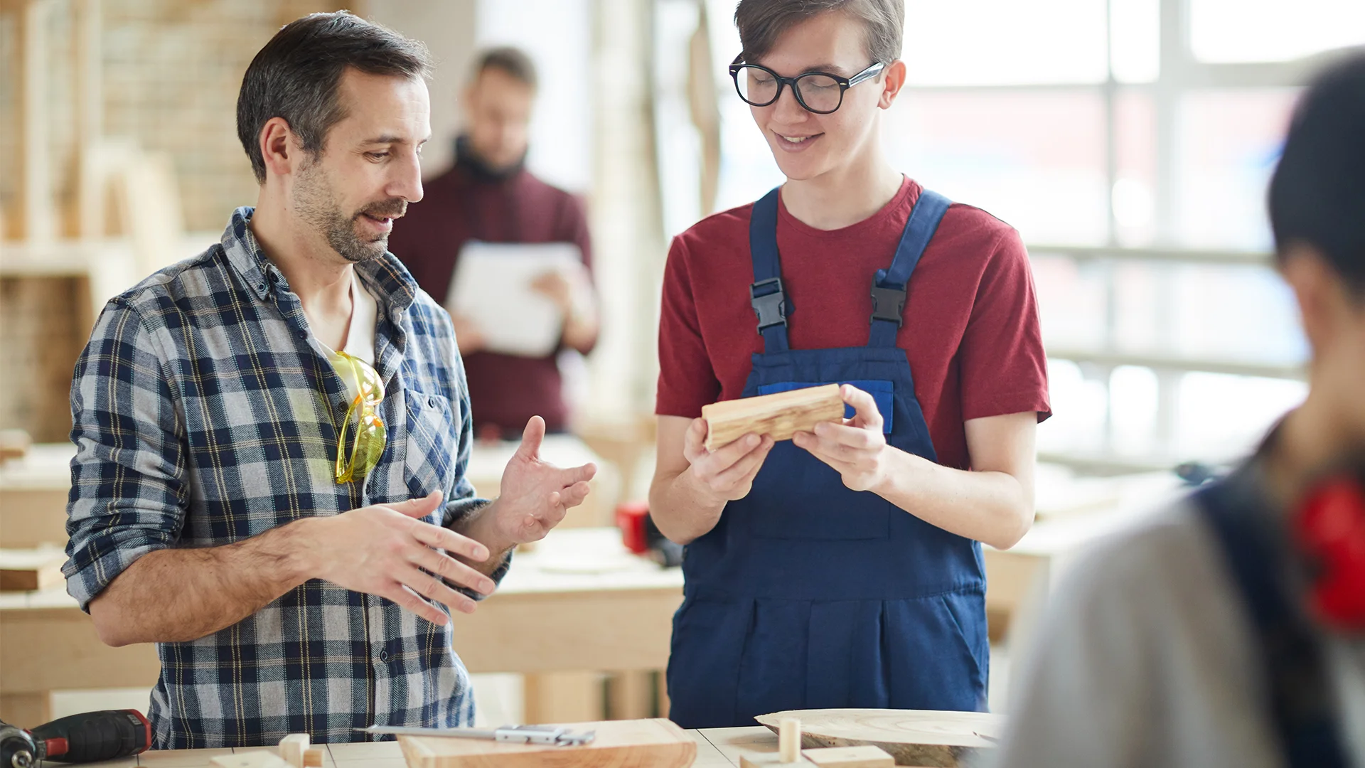 Mature Carpenter Talking to Apprentice